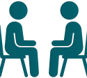 Two teal silhouettes of adults sitting in chairs facing each other, representing psycho-pedagogical interventions for adults.